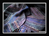 T021.  Handwoven rayon chenille/tencel neck scarf, plain weave structure, 66x6 inches with 6 inches of fringe.  Titled Jeweltone.