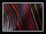T025.  Handwoven tencel shawl, Divinity weave structure, 60x11 inches with 6 inches of fringe.  Titled Mining Rainbow.Jeweltone.